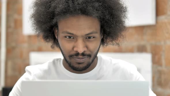 Close Up of African Man Working on Laptop