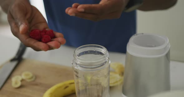 Video of african american senior man preparing smoothie