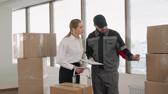 Moving to a New Office Female Office Manager Accepts a Large Number Delivered Parcels in Cardboard