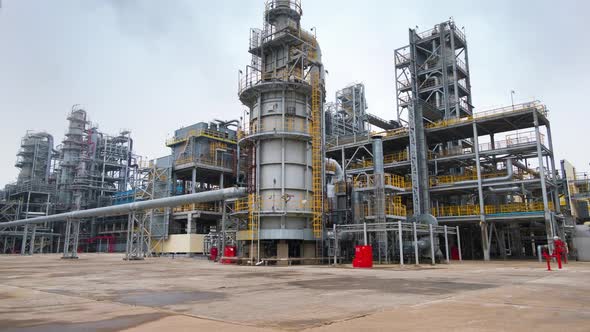 Steel epic structures of a large oil refinery against a cloudy sky