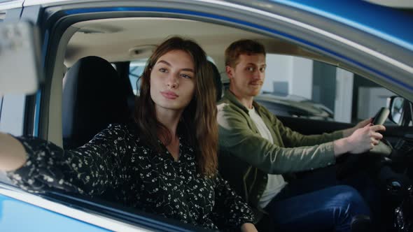 Couple Takes a Selfie in a New Car They Bought at a Dealership