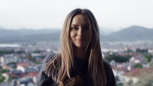 Blonde Woman Look Straight to Camera While Standing at Nice Viewpoint