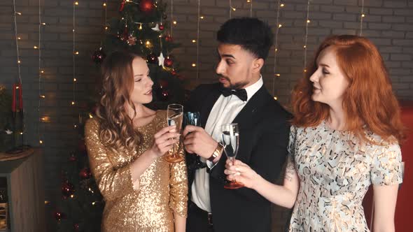 Mixed Race Friends Clinking at Holiday Party in New Year