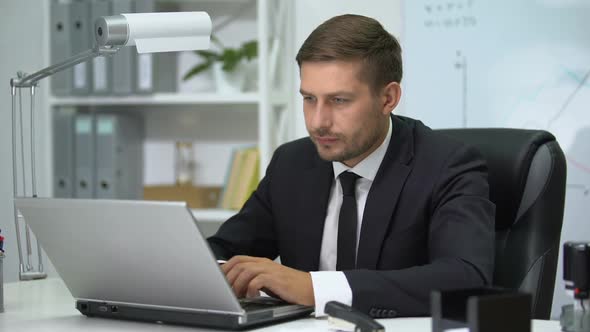 Serious Business Person Typing on Laptop, Suddenly Feeling Strong Pain in Heart