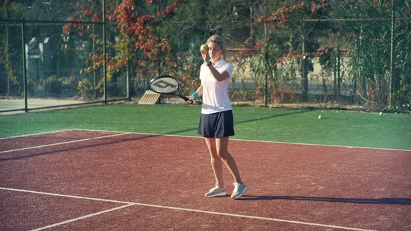 Female Tennis Player Preparing To Set Ready To Serve Ball. Girl With Rocket Playing On Tennis Court.