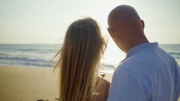 Couple Holding Glasses of Wine at Seaside