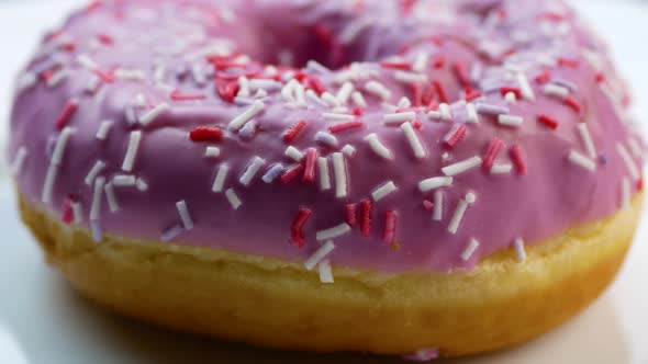 Close up of tasty fresh donut rotation. Sweet dessert for kids.