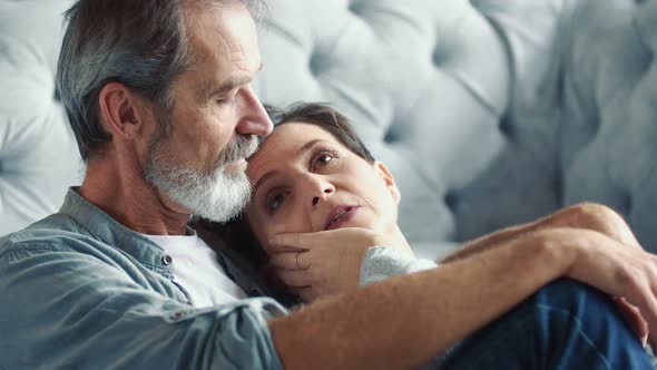 Elderly Couple Sitting Near the Sofa