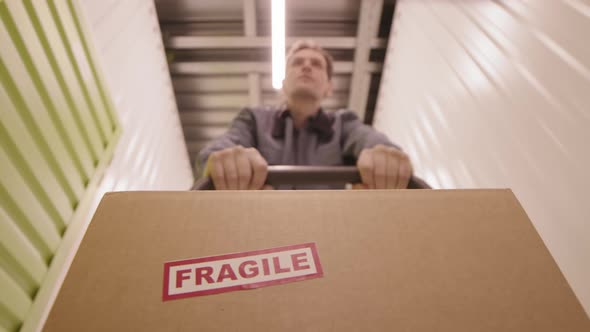 Pushing Trolley with Box with Fragile Content