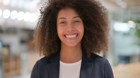 Smiling Young African Businesswoman Looking at Camera 