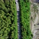 Aerial top view of mountain twisted road and Van or Bus driving to the mountains. Transportation. - VideoHive Item for Sale