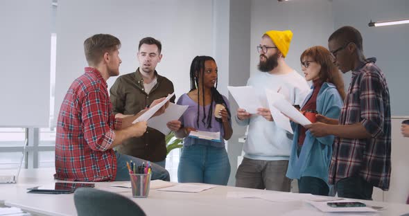 Group of Young Business People Discussing Startup Project Working Together in Creative Office