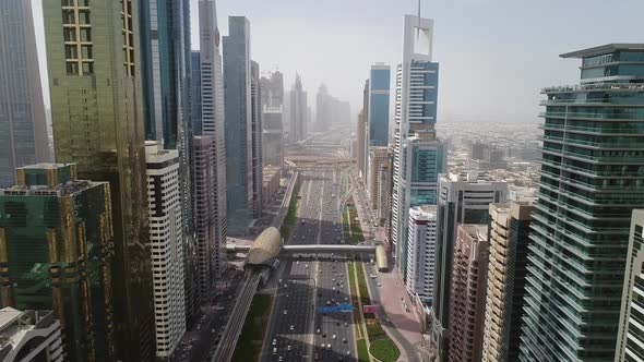 Aerial view of Dubai colourful skyscrapers, and long busy road ,UAE.