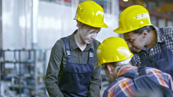 Young Woman Working at Factory with Female Coworkers