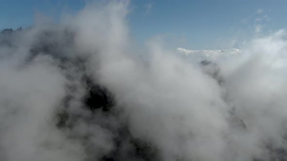 Aerial view of the mountains and the clouds at Pico Ruvio in Madeira, Portugal. alt
