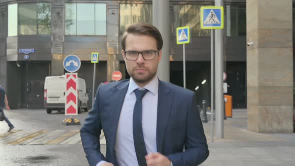 Businessman Running in Street in Slow Motion, side Pose