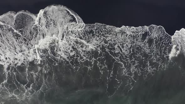 Aerial Top View Beautiful Nature of Volcanic Black Sand Beach and Giant Waves