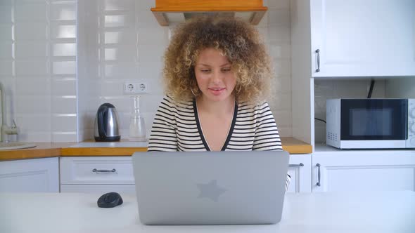 Young white female studying online with notebook computer at home on lockdown in 4k video