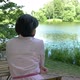 Middle-aged Woman Resting Near the Pond, Sitting at a Table - VideoHive Item for Sale