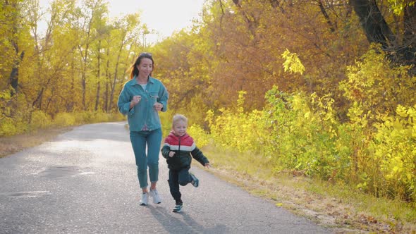 Cute Little Boy and Mother During the Walk in Nature