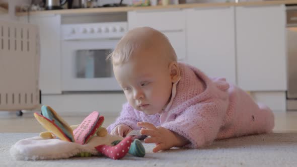 Adorable Baby Girl Playing at Home on the Carpet