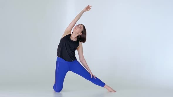 Fit Woman in Sportswear Practicing Yoga Gate Pose at Home