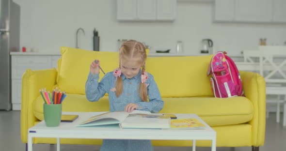 Exhausted Little Pupil Tired of Studying at Home