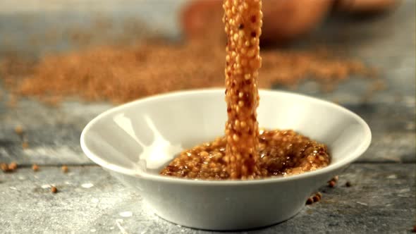 Super Slow Motion Fresh Mustard Falls Into a Plate on the Table