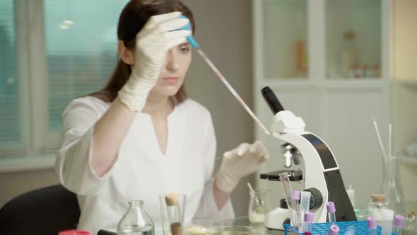 Female Doctor In Laboratory With Microscope alt
