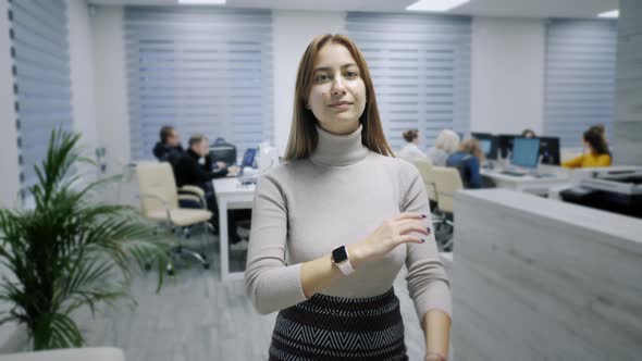 Portrait of Happy Office Worker Looking at Camera in Modern Office, Positive Female Employee with