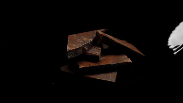 Dark Chocolate Stack Covered By Splashing White Milk and Cocoa Drink, Slow Mo