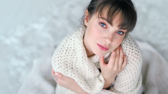 Romantic Young European Woman Getting Warm Wrapped in White Knitted Plaid