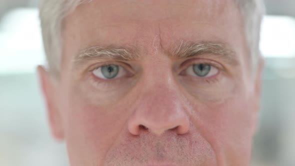 Close Up of Blinking Eyes of Middle Aged Man