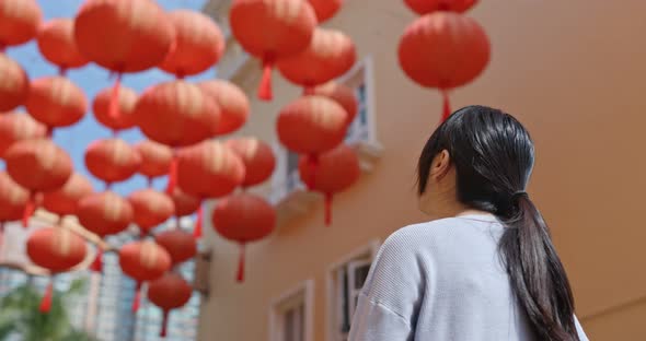 Young Woman look at the red lantern in the street
