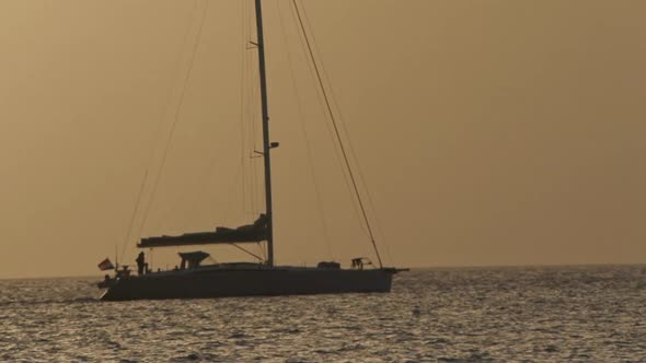 Sailboat sailing at sunset in Ibiza in slow motion