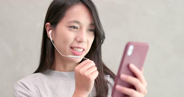 Woman talking on hand free with mobile phone 