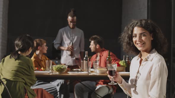 Mixed-race Brunette Having Dinner with Friends