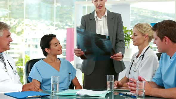 Medical team looking at Xray during meeting