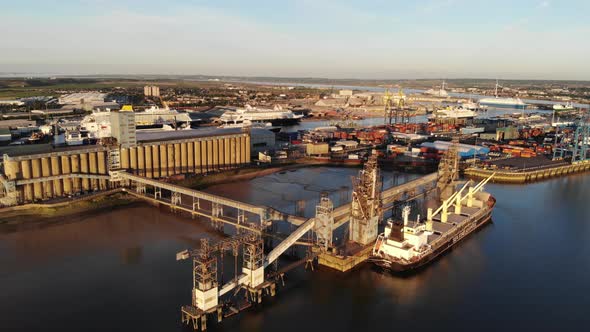 Flying towards London container Terminal at sunset