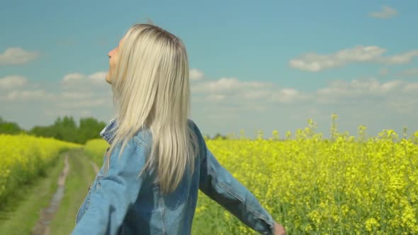 Pretty Woman with White Hair Walks Across Field Looks at Camera Spins Around