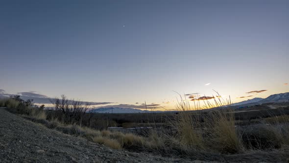Twilight time lapse with the crescent moon and cloudscape - static wide angle