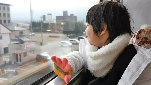 Happy Asian Child Looking Out Train