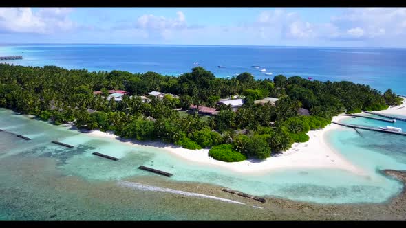 Aerial tourism of tranquil lagoon beach break by blue green sea with white sand background of journe