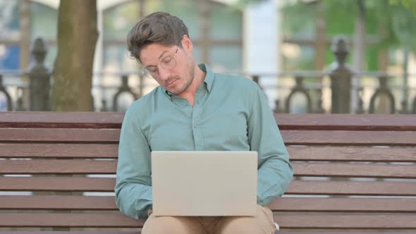 Middle Aged Man Falling Asleep while using Laptop Outdoor, Nap