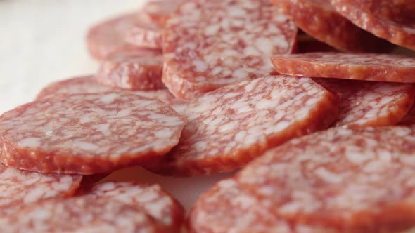 Cured sausage air-dried meat cuts pile slow pan 4K 2160p 30fps UltraHD footage - Dry  salami pieces 