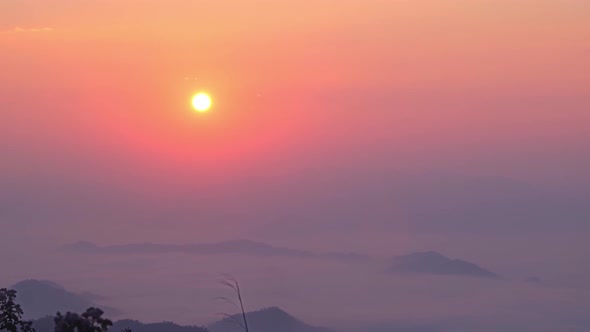 4K : Timelapse of colorful sunrise over the heavy fog in the during morning