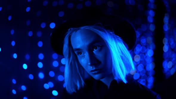 Millennial Enigmatic Pretty Girl Blond Hairstyle Near Glowing Neon Wall at Night. Blue Hair, Hipster
