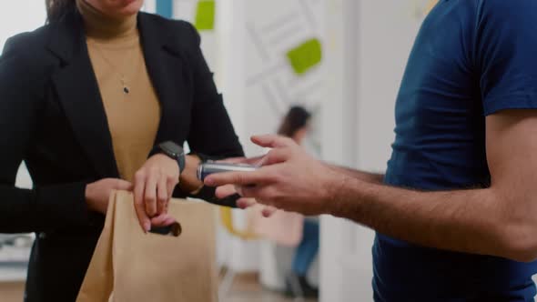 Closeup of Businesswoman Paying Food Order Having Contactless Payment with Smart Watch