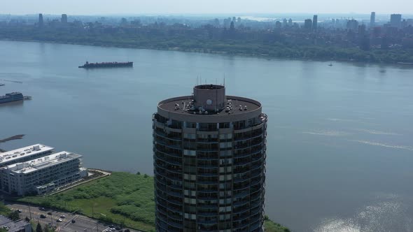 A drone view of the Hudson River from NJ on a sunny day. The camera pan lefting around a building wi