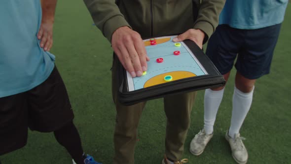 Soccer Coach Giving Personal Instructions to Each Sportsman Outdoors